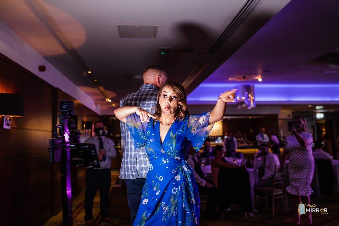 Guest on the 360 photo booth platform under string lights at an NYC event